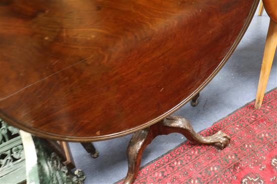 A George III mahogany tea table, with dished top and acanthus carved tripod W.85cm